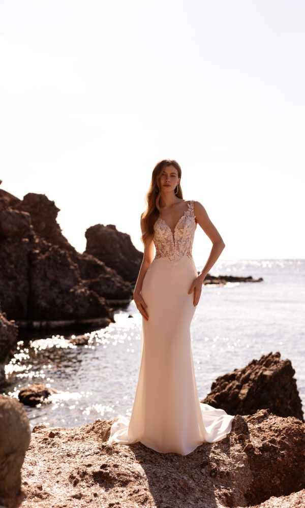robe de mariée Demetrios DR420 coupe sirène avec bustier en dentelle transparente, dos échancré et jupe fluide au bord de mer